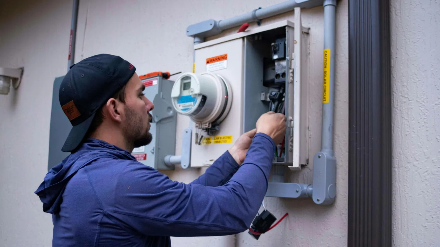 Electrician working on an electrical panel