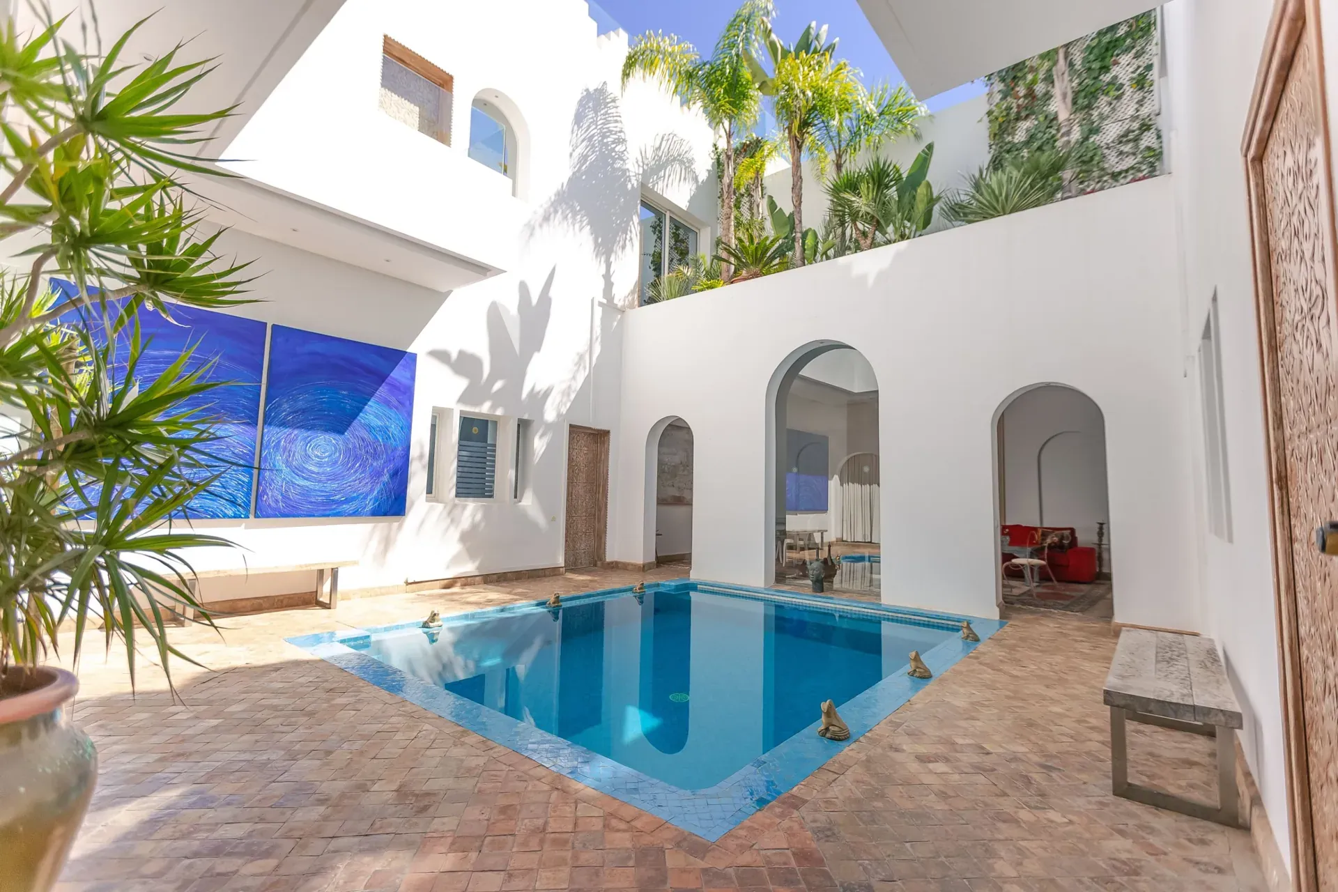 Courtyard with a pool and plants in a Moroccan home